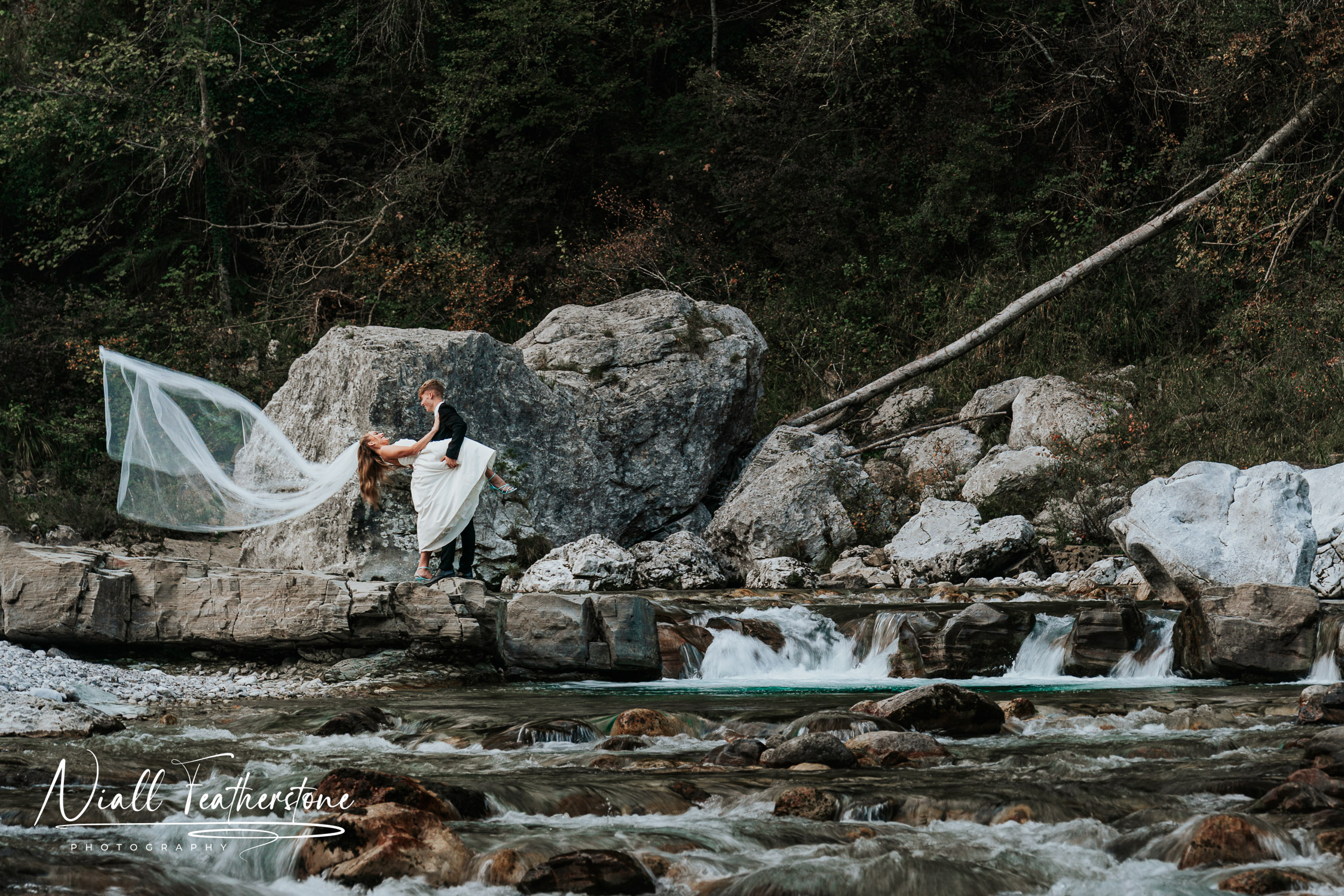 Wedding Couple dipped down with a Veil Toss by river