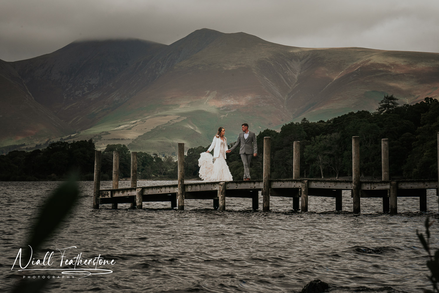 Couple Posed on a pier in the Lake District 
