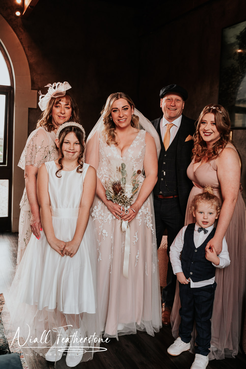 Bride having formal photographs taken with family and Maid of honour