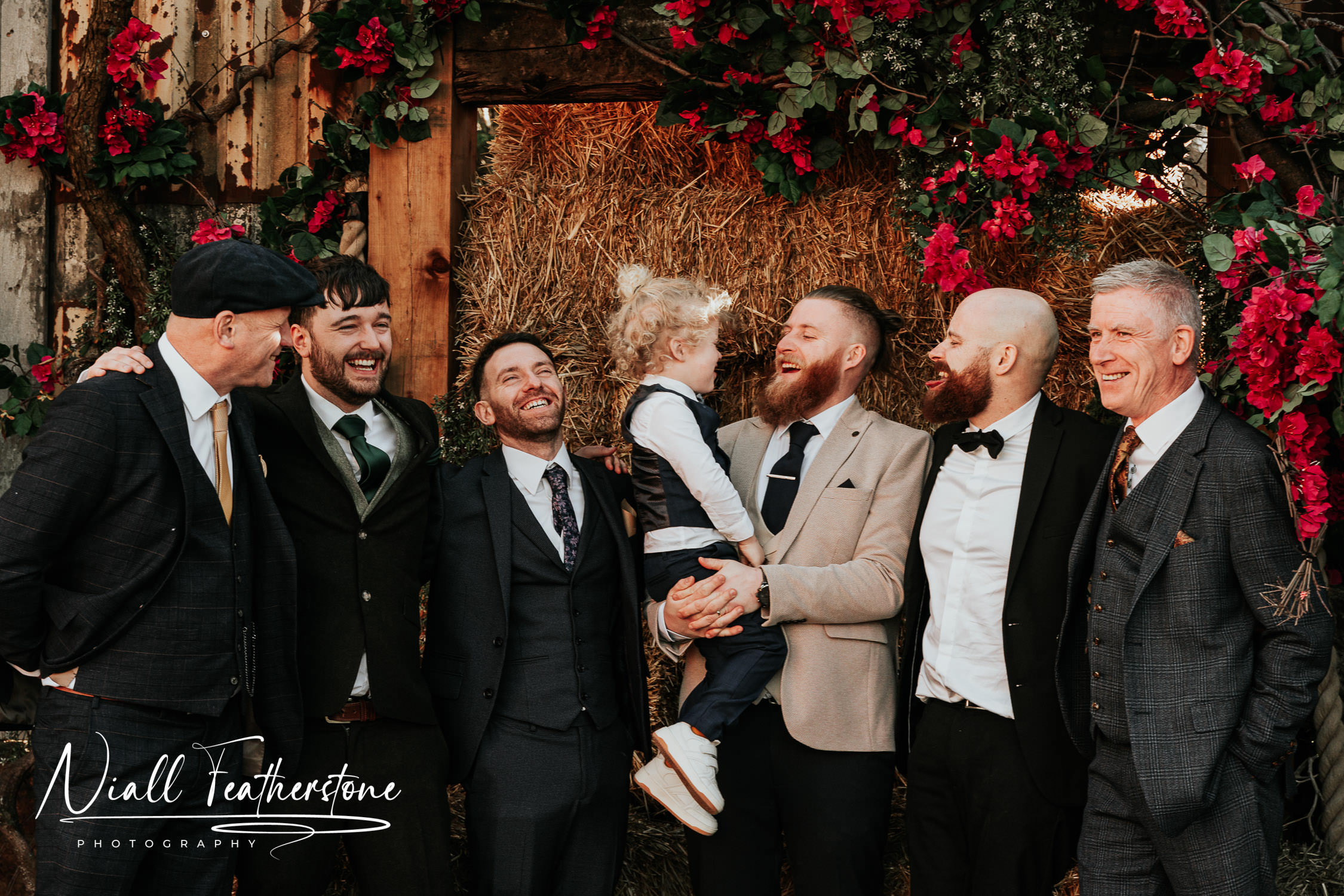 Groomsmen Laugh and cheers together at Runa Farm wedding Venue