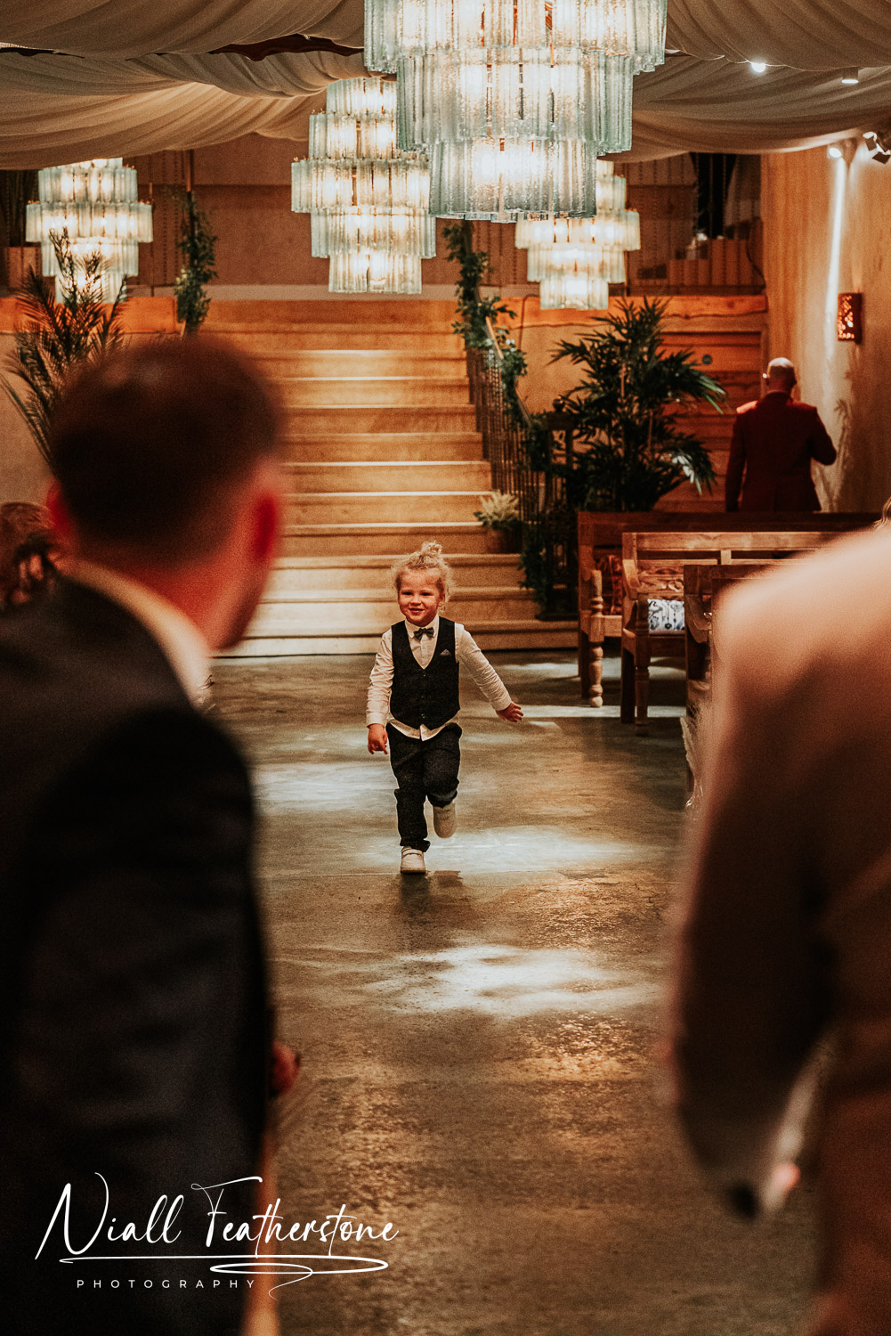 Grooms son running down aisle at wedding ceremony to be with his father