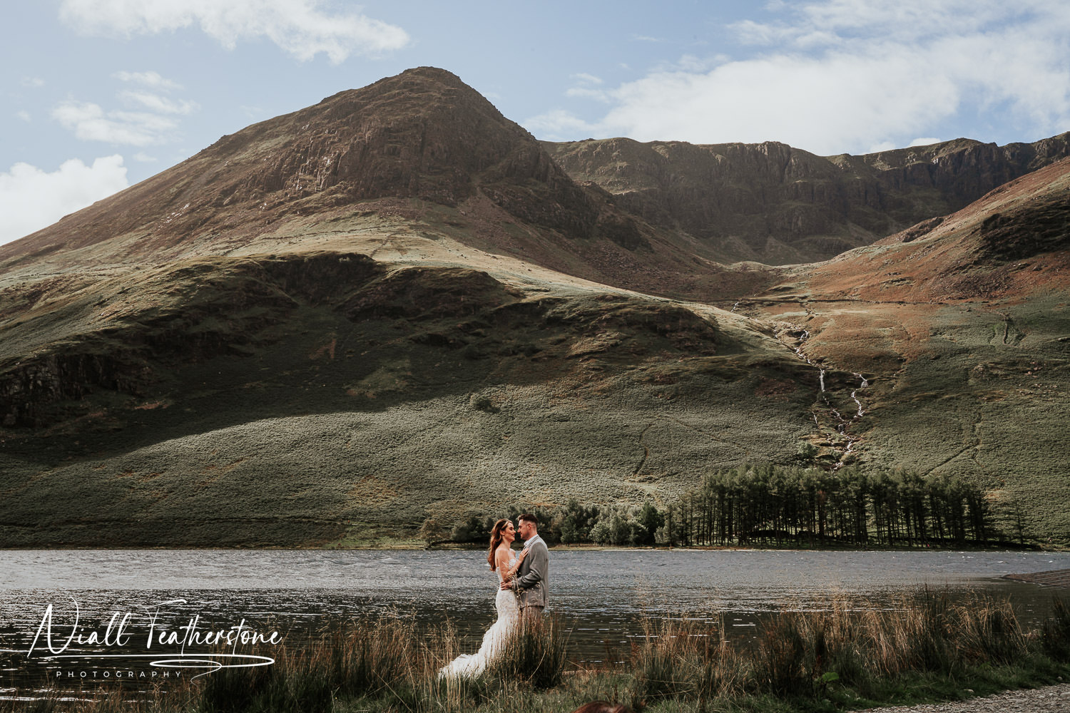 Wedding Photography couple posed in front of Mountains in Lake District