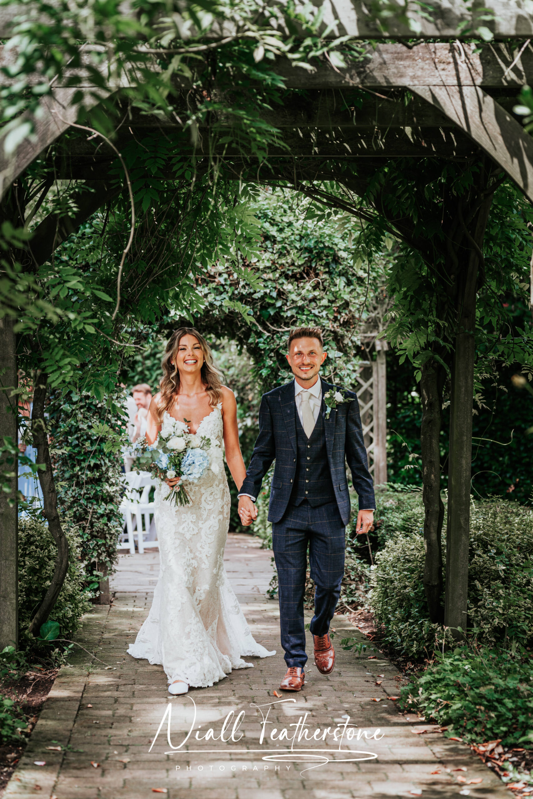 Bride and Groom walking out from outdoors ceremony hand in hand
